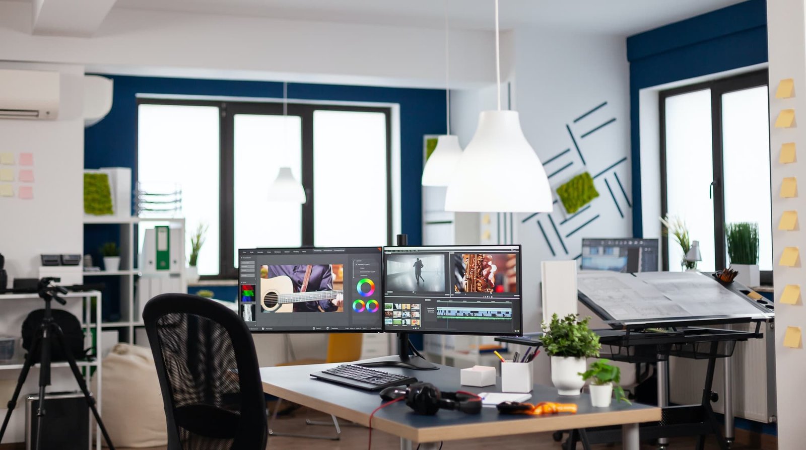 Empty modern creative agency office with dual monitors setup